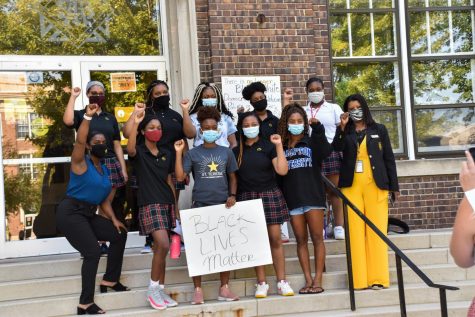 The Black Student Coalition poses with Brianna Walker and Dr. Siabahn May-Washington Sept. 3, 2020. They hold up clenched fists that represent the logo for the resurgence of the Black Lives Matter movement. Photo courtesy of Claire Smith. 