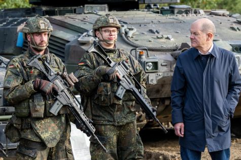 German Chancellor Olaf Scholz inspects tanks at a training center in Osterholz, Germany. 
photo by David Hecker; photo courtesy Getty Images.