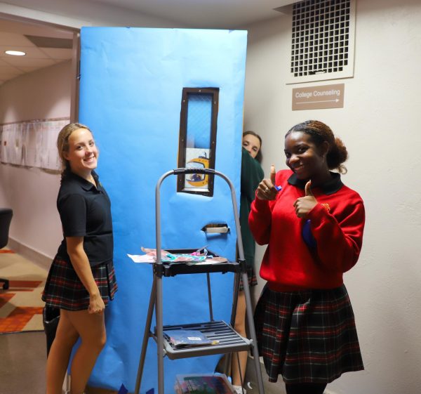 Junior Janie Gacek and Senior Chelley Young decorate their door for the Door Decorating Contest Oct. 25. photo by Jasmine Cervantes.