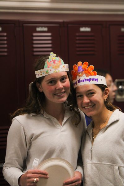 Seniors Gianna Giocondo and Francie McCray smile with their festive Thanksgiving hats.